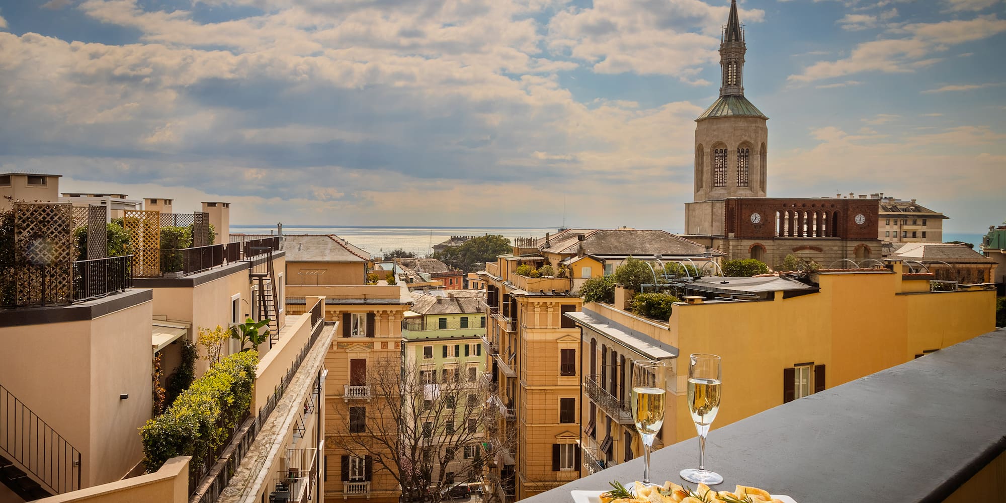 a plate of food on a table with a glass of champagne
