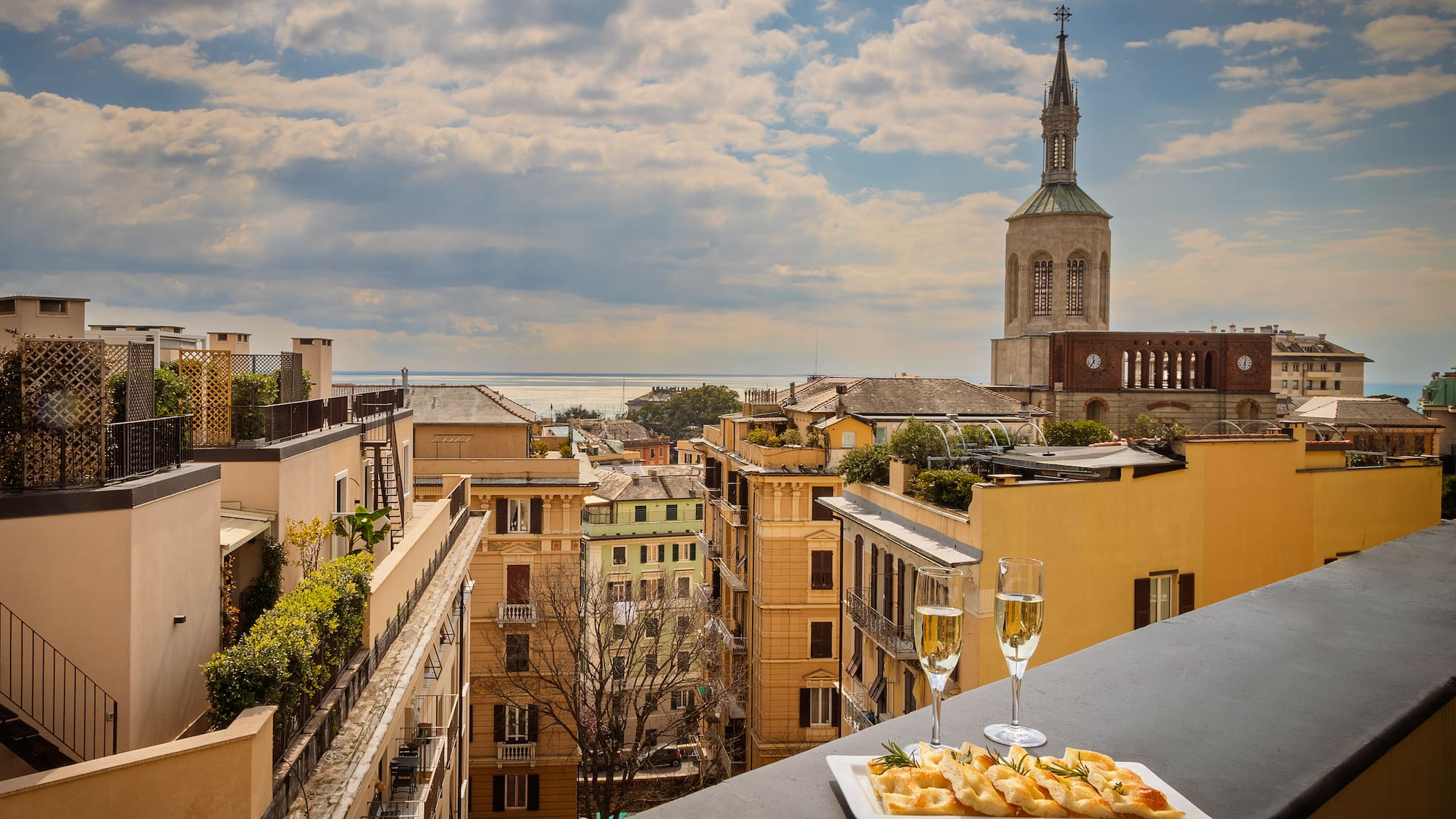a plate of food on a table with a glass of champagne
