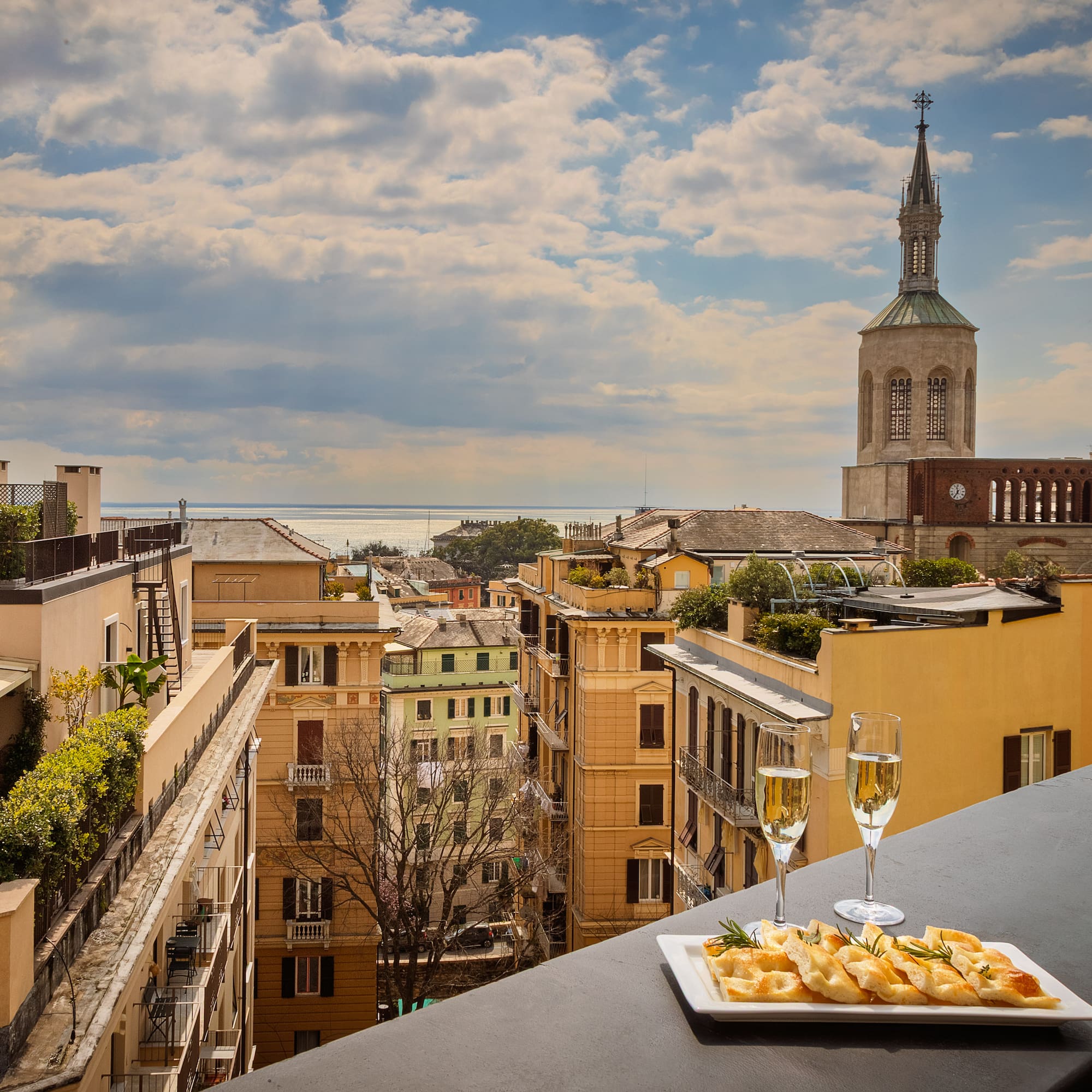 a plate of food on a table with a glass of champagne