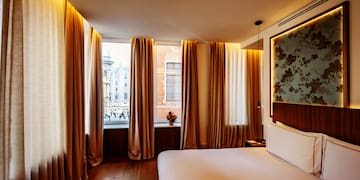 a room with a bed and curtains