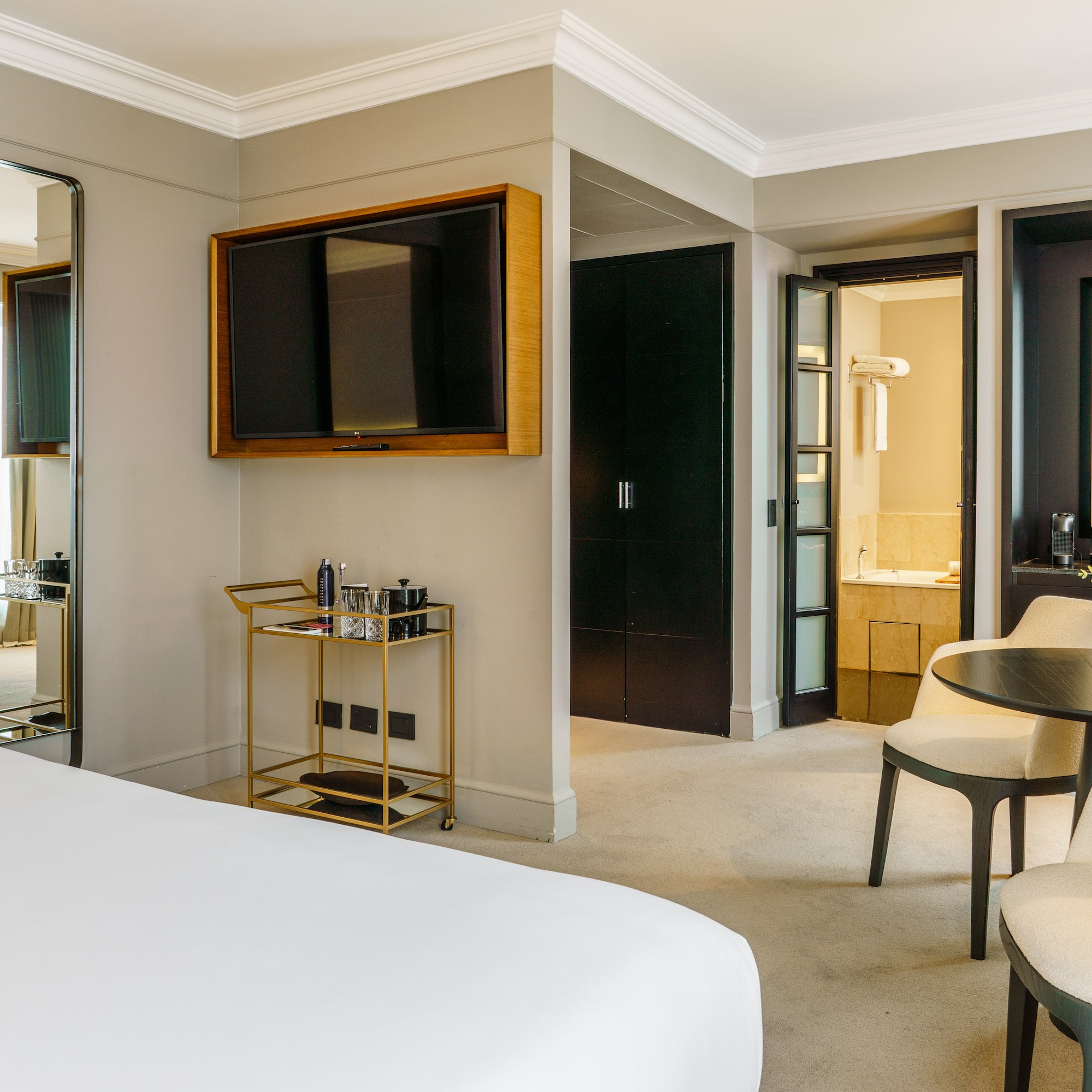 a room with a bed and a table and chairs