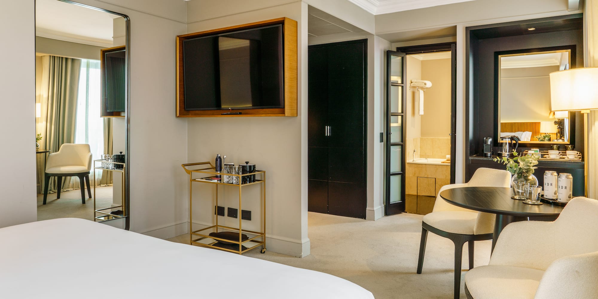 a room with a bed and a table and chairs