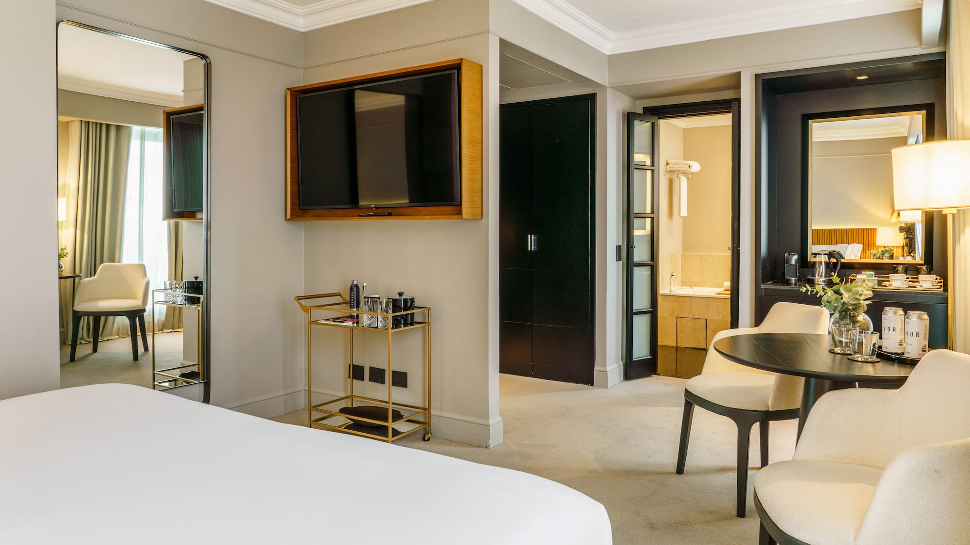 a room with a bed and a table and chairs