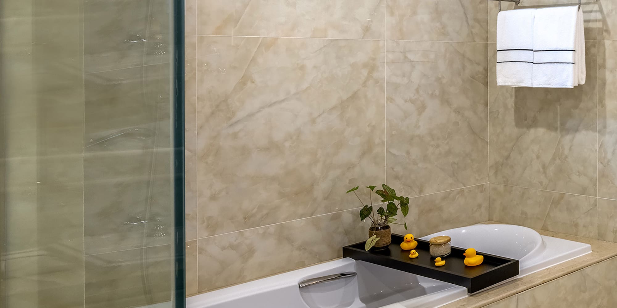 a bathroom with a glass shower door