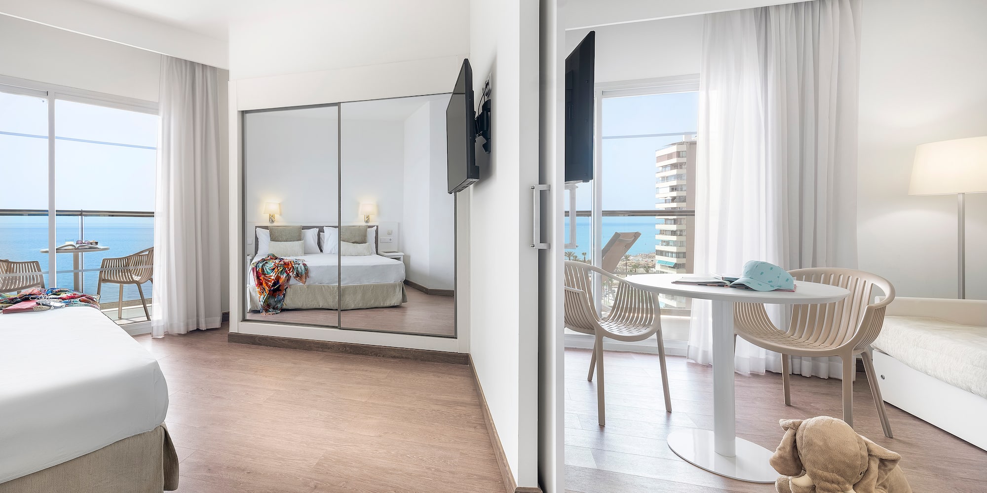 a room with a mirror door and a bed and a table