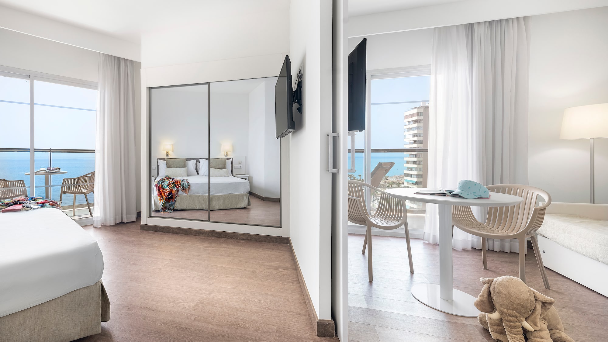 a room with a mirror door and a bed and a table