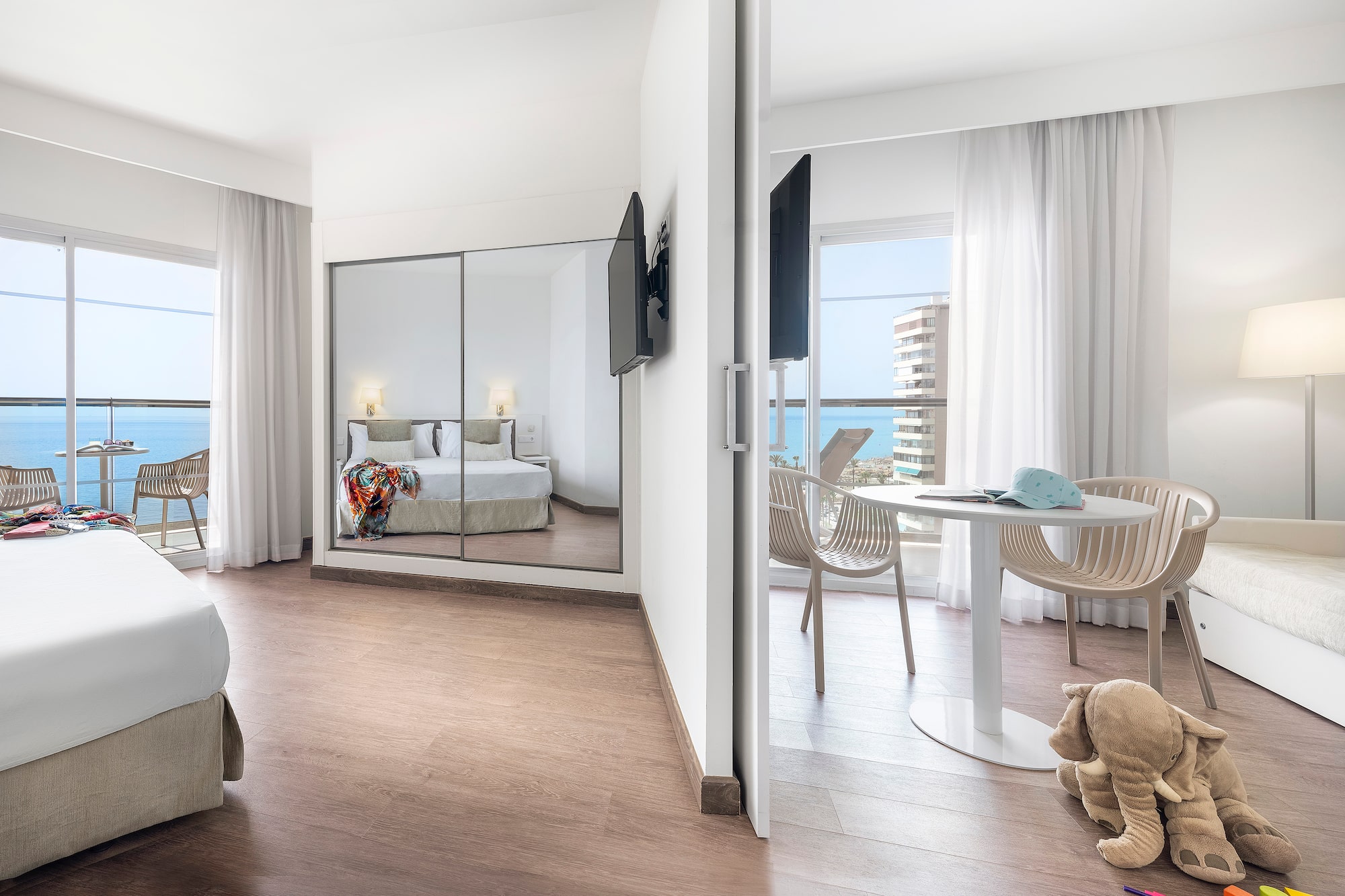 a room with a mirror door and a bed and a table