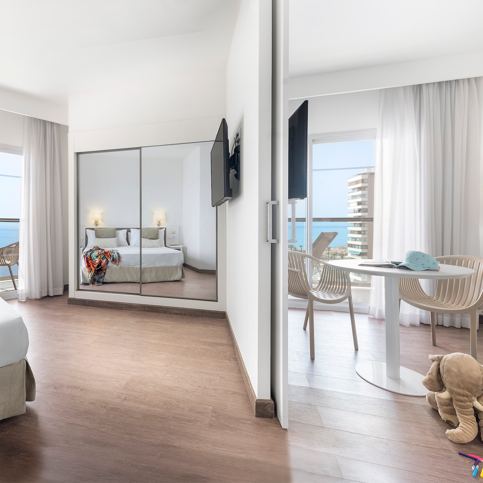 a room with a mirror door and a bed and a table