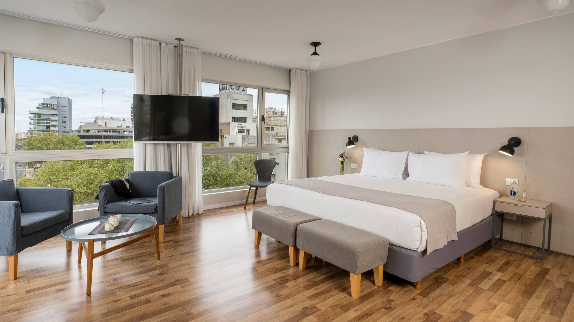 a bedroom with a large bed and a television