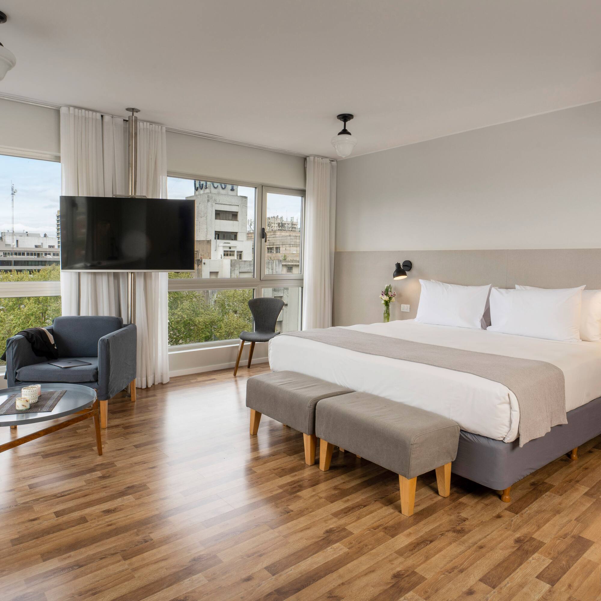 a bedroom with a large bed and a television