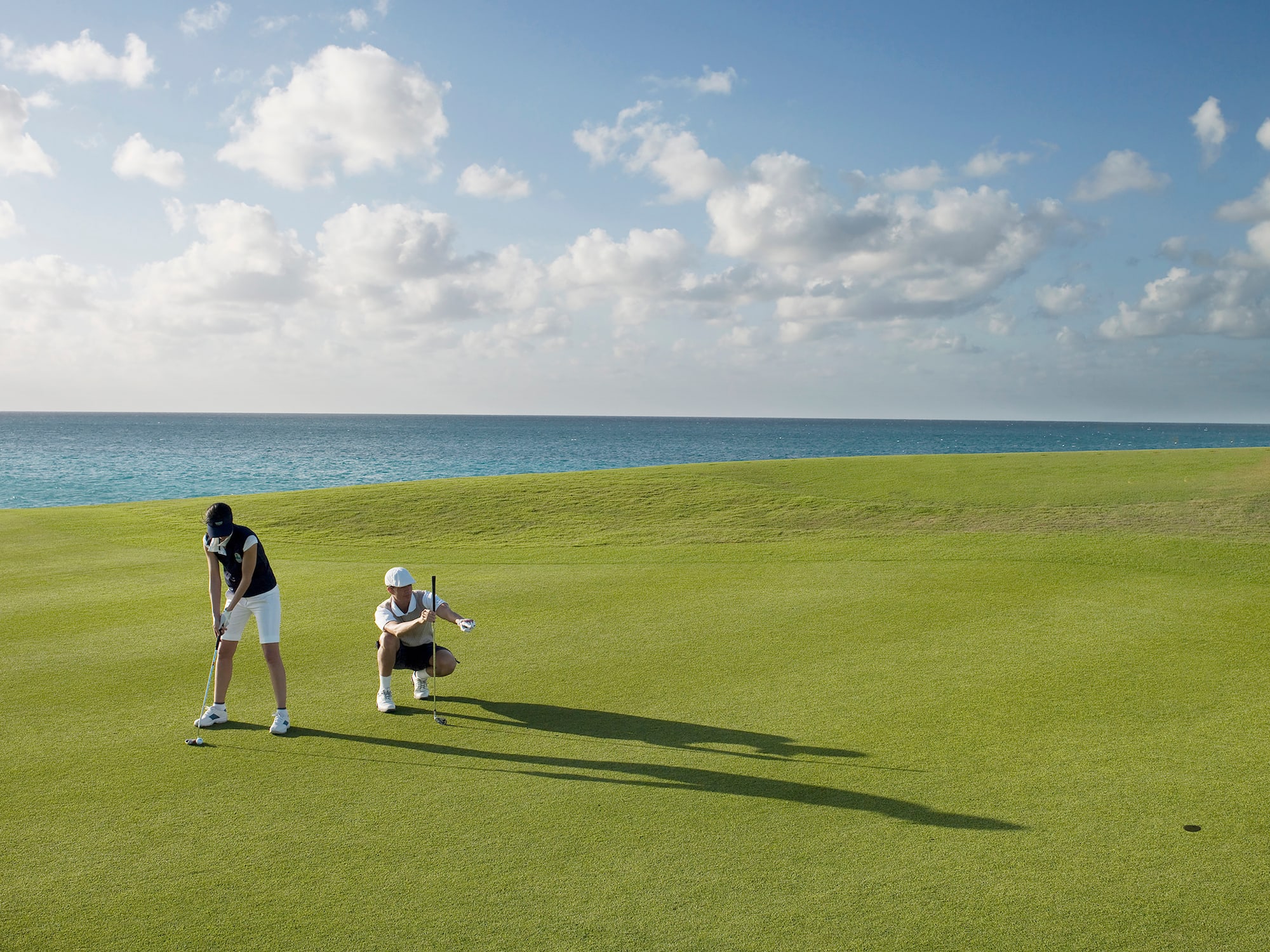 a man and woman playing golf