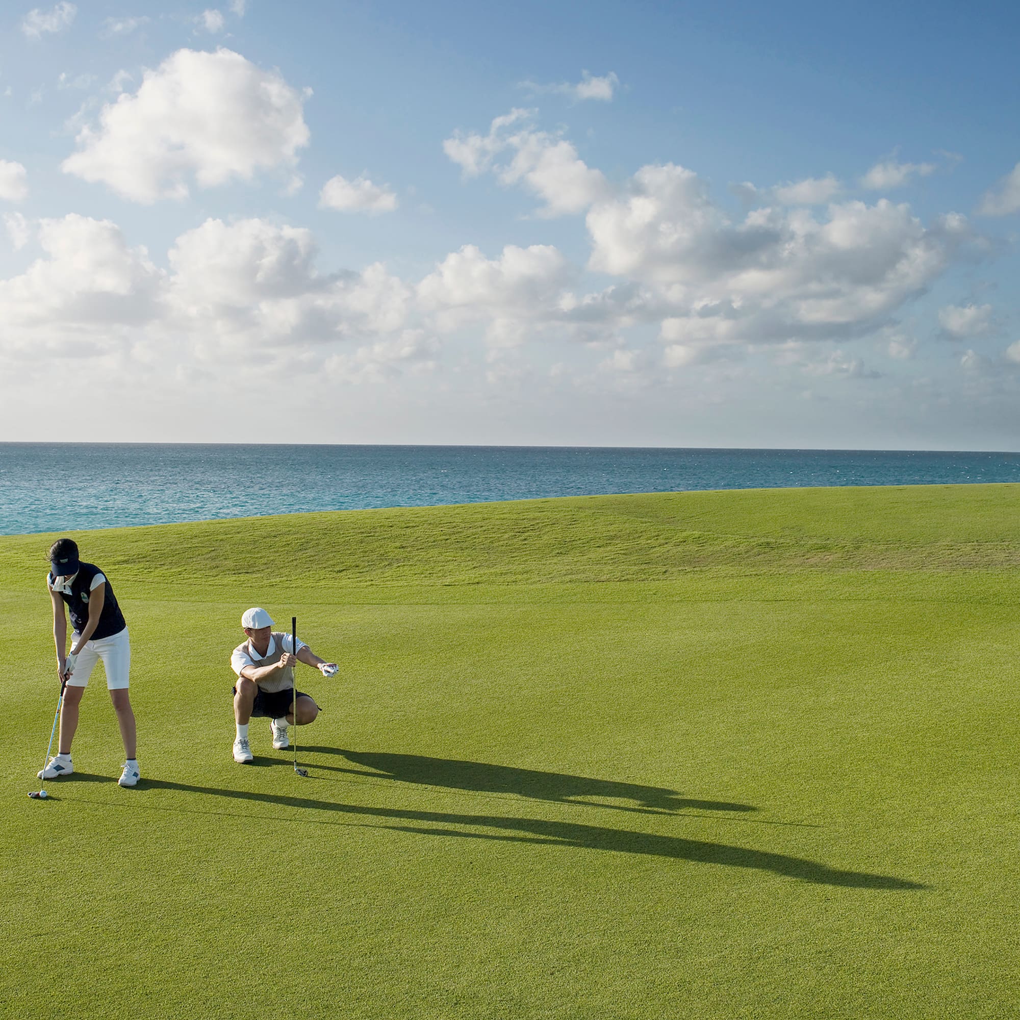 a man and woman playing golf