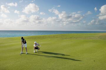 a man and woman playing golf