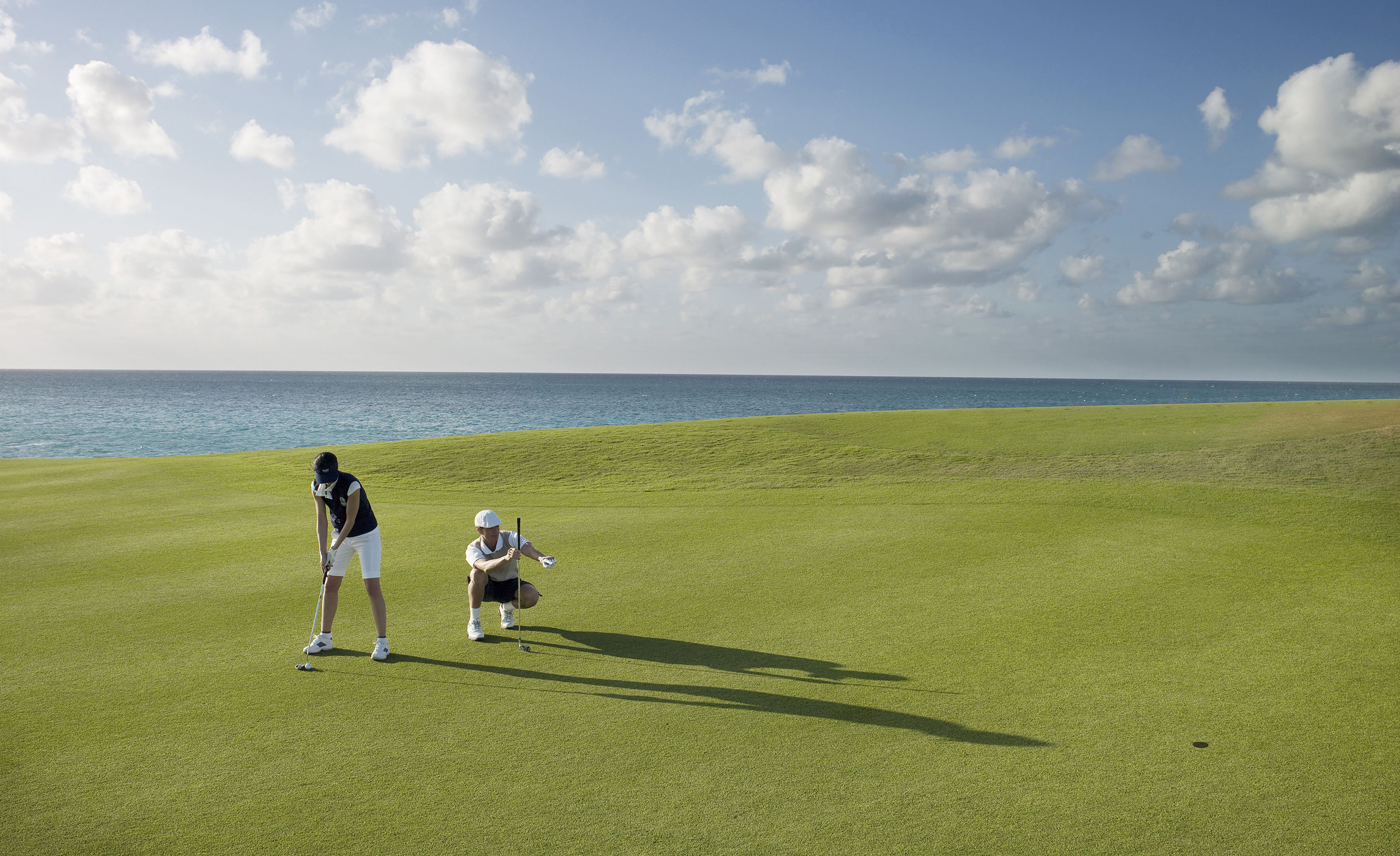 a man and woman playing golf