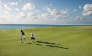 a man and woman playing golf