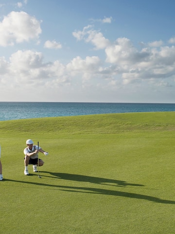 a man and woman playing golf