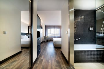 a room with a bathtub and beds