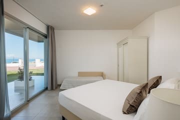 a bedroom with a bed and a glass door