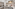 Compact white kitchenette with sink, stove, fridge, microwave, toaster, and kettle.