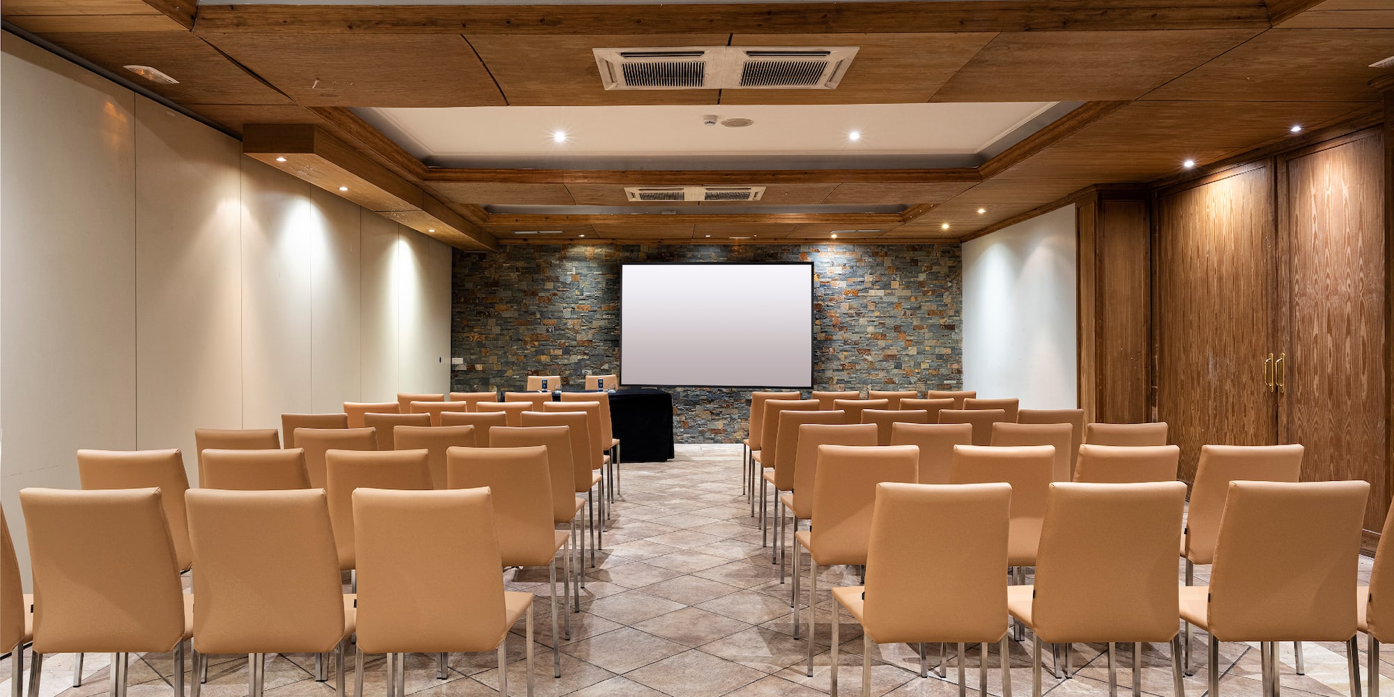 a room with chairs and a projector screen