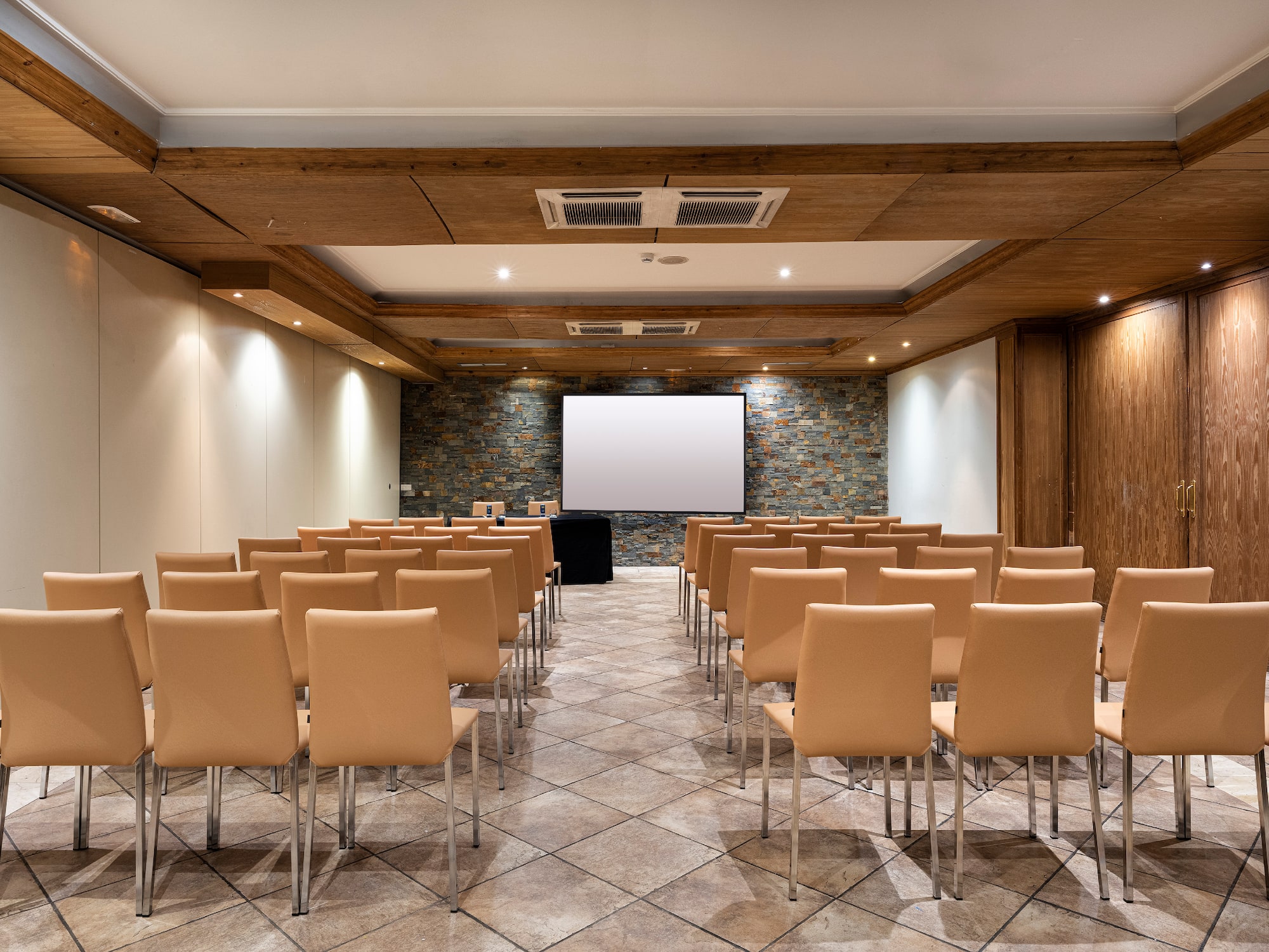 a room with chairs and a projector screen