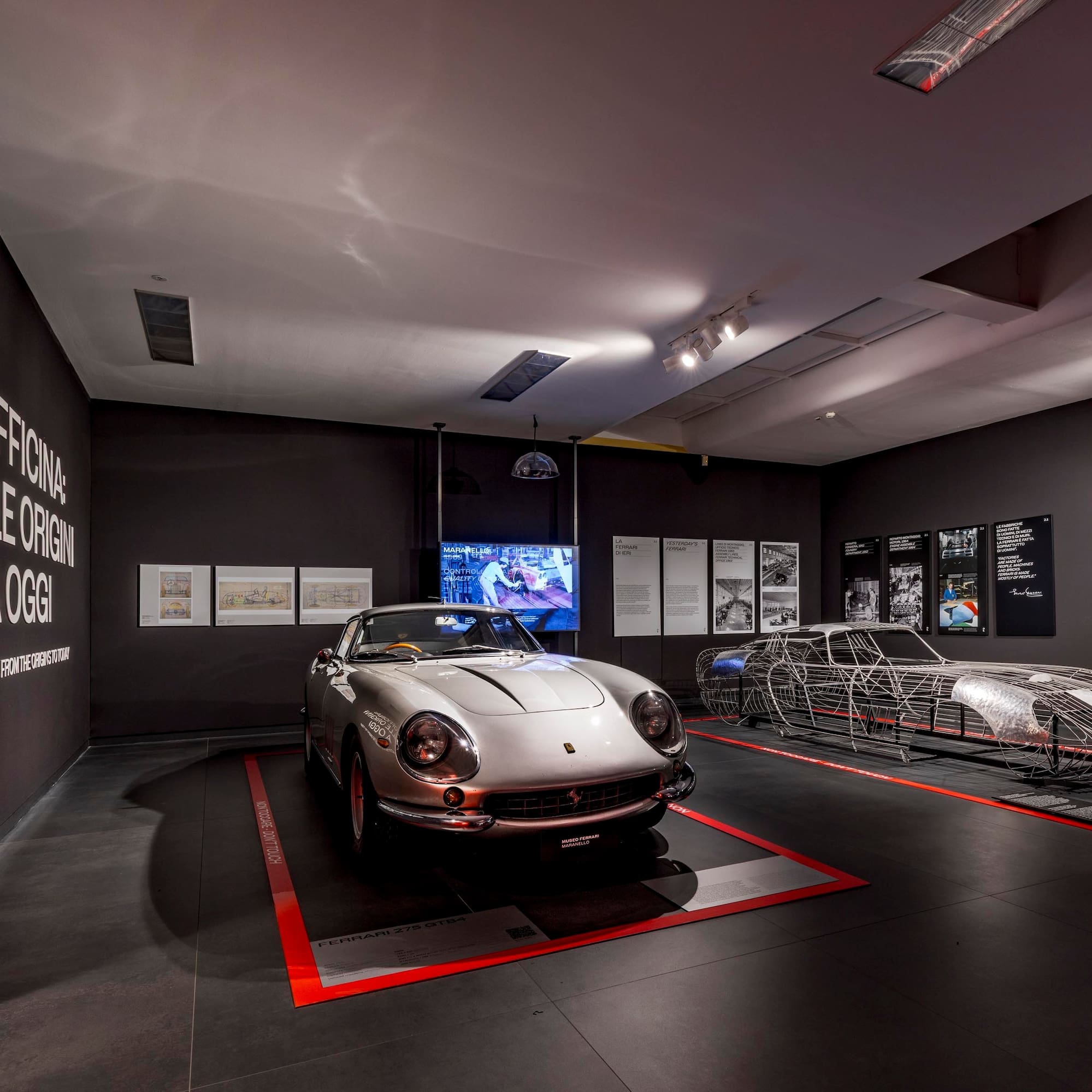a car in a room with several metal sleds