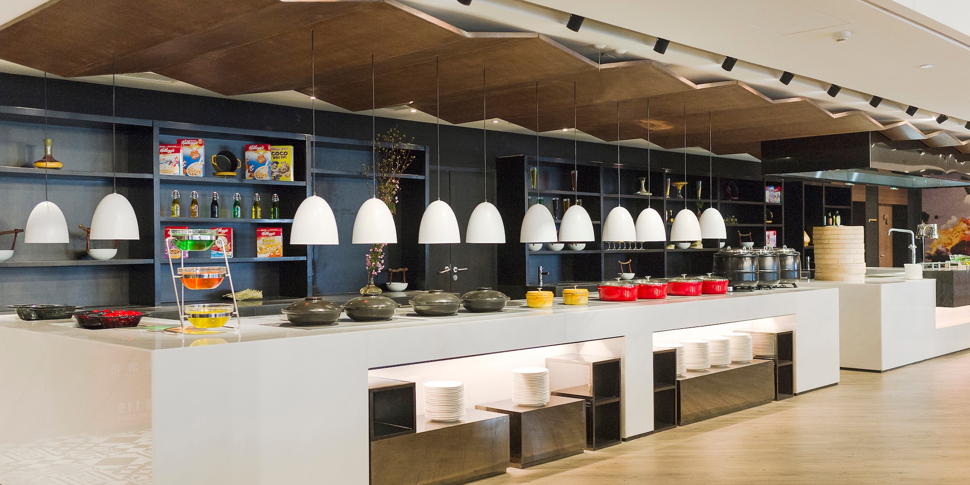 a buffet line with bowls and bowls on the counter