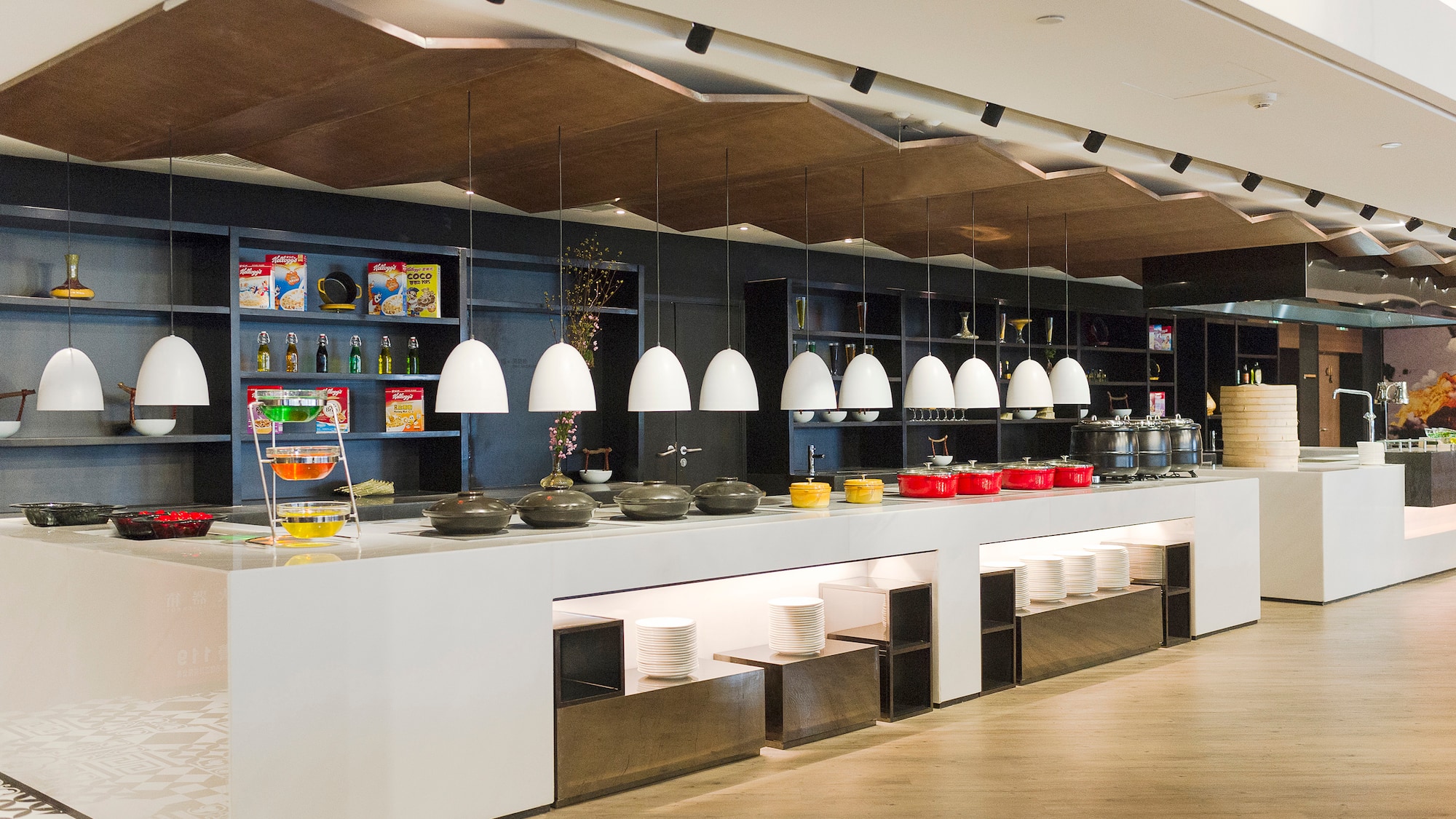 a buffet line with bowls and bowls on the counter