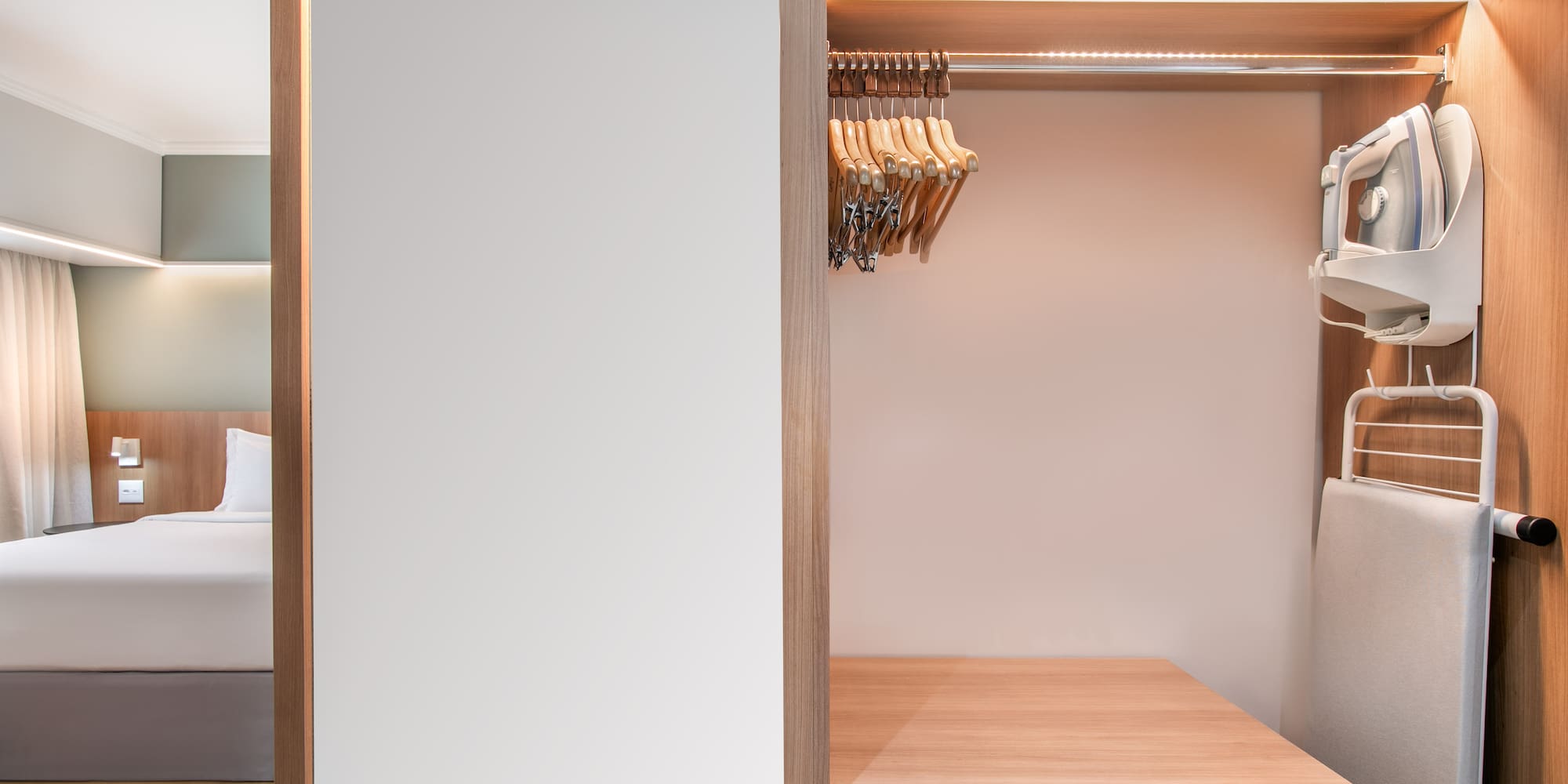 a closet with a white wall and a white wall