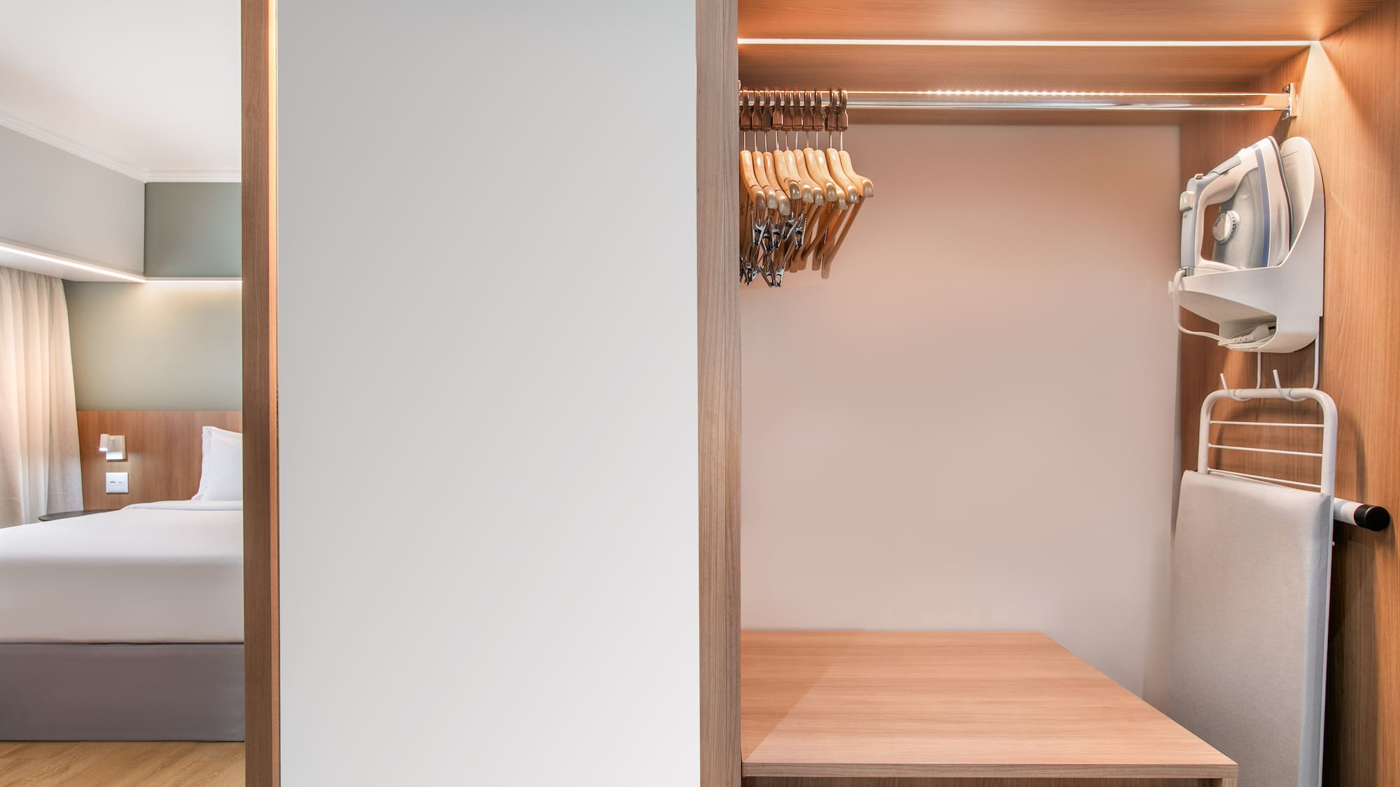 a closet with a white wall and a white wall