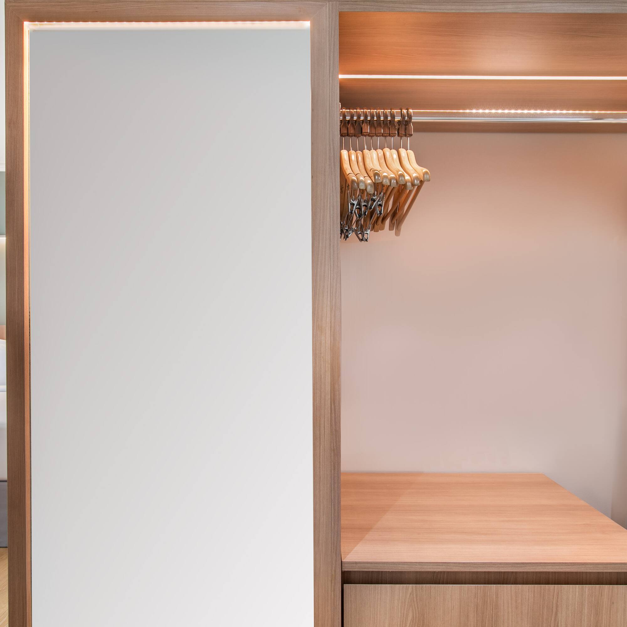 a closet with a white wall and a white wall