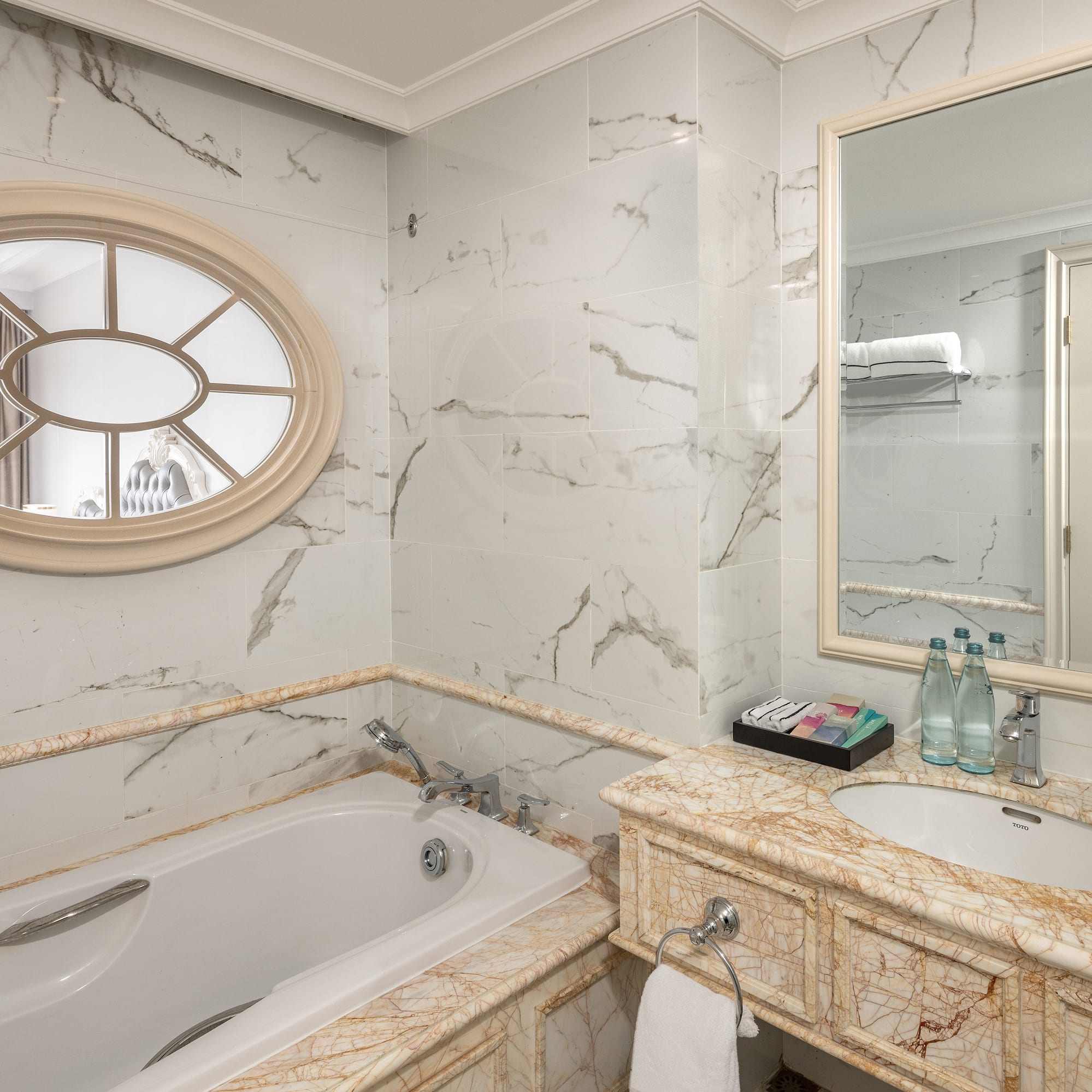 a bathroom with marble countertop and sink