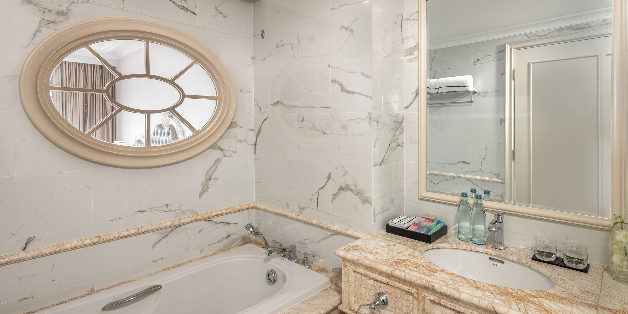 a bathroom with marble countertop and sink